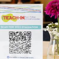 Teach-In flyer next to a flower in a vase